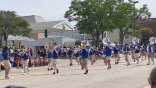 A band marches in the Fourth of July parade in Highland Park moments before shooting begins. (Jay T. Smith / WTTW News)