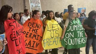 Activists protest plans for a metal scrapper on Chicago's Southeast Side at City Hall on Tuesday, June 6, 2023. (Heather Cherone/WTTW News)