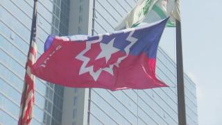 The Juneteenth flag is raised in Chicago during a ceremony on June 17, 2024. (WTTW News)