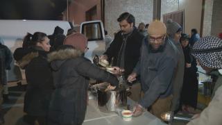 Volunteers with the Ojala Foundation distribute food. (WTTW News)