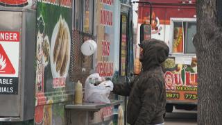 A customer makes a purchase from a Little Village food truck vendor. (WTTW News)