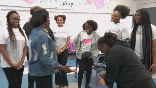 A Ladies of Virtue mentor works with a group of girls. (WTTW News)