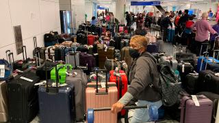 Baggage waits to be claimed after canceled flights at the Southwest Airlines terminal at Los Angeles International Airport on Monday, Dec. 26, 2022, in Los Angeles. (Eugene Garcia / AP)