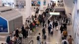 People wait in line at a Transportation Security Administration (TSA) security checkpoint at LaGuardia Airport (LGA) in the Queens borough of New York, Sunday, Nov. 9, 2025. (AP Photo / Adam Gray)