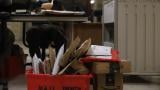 A group of jail personnel inspect stacks of letters and books in the mail room at Cook County Jail in a file photo. Illinois Department of Corrections will begin scanning mail in state prisons. (Cary Robbins / DePaul)