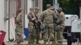 Military personnel in uniform, with the Texas National Guard patch on, are seen at the U.S. Army Reserve Center, Tuesday, Oct. 7, 2025, in Elwood, Ill., a suburb of Chicago. (AP Photo/Erin Hooley)