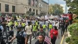 Protesters walk down Michigan Avenue during the "No Kings" march Oct. 18, 2025. (Bridgette Adu-Wadier / WTTW News)