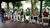 Visitors pay their respects, Thursday, July 7, 2022, at altars for the seven people killed in the Fourth of July mass shooting in Highland Park, Ill. (AP Photo / Nam Y. Huh, File)