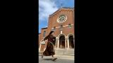 Sister Stephanie Baliga runs past the Our Lady of the Angels church in Chicago. (Jay Shefsky / WTTW News)