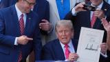 House Speaker Mike Johnson of La., points to President Donald Trump after he signed his signature bill of tax breaks and spending cuts at the White House, Friday, July 4, 2025, in Washington, surrounded by members of Congress. (AP Photo / Evan Vucci)