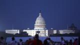 The U.S. Capitol building stands as people wait to watch fireworks near the Washington Monument during Fourth of July celebrations, in Washington, Friday, July 4, 2025. (AP Photo / Rahmat Gul)