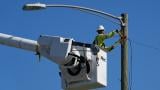 An electrical worker repairs power lines along a street in Gary, Ind, Thursday, Aug. 20, 2026, more than a week after a deadly storm passes through the area. (AP Photo/Nam Y. Huh)