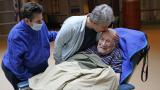 Melvin Goldstein, 90, smiles as his daughter Barbara Goldstein gives him a kiss on the head during their first in-person, indoor family visit inside the Hebrew Home at Riverdale, March 28, 2021, in the Bronx borough of New York. (AP Photo / Kathy Willens, File)