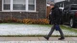 Pedestrian walks on the sidewalk during a snowy day in Skokie, Ill., Sunday, Nov. 9, 2025. (AP Photo / Nam Y. Huh)