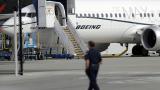 In this March 14, 2019, file photo a worker walks next to a Boeing 737 MAX 8 airplane parked at Boeing Field in Seattle. (AP Photo / Ted S. Warren, File) In this March 14, 2019, file photo a worker walks next to a Boeing 737 MAX 8 airplane parked at Boeing Field in Seattle. (AP Photo / Ted S. Warren, File)