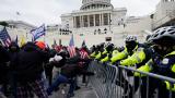 FILE - Rioters loyal to President Donald Trump push against a line of police at the U.S. Capitol in Washington on Jan. 6, 2021. (Julio Cortez / AP Photo, File)