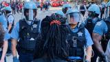 A protester faces off against police in Chicago on Saturday, May 30, 2020. (Hugo Balta / WTTW News) A protester faces off against police in Chicago on Saturday, May 30, 2020. (Hugo Balta / WTTW News)