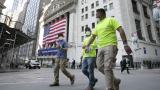 Workers wearing masks walk by the New York Stock Exchange during the coronavirus pandemic, Thursday, July 9, 2020, in New York. (AP Photo/Mark Lennihan) Workers wearing masks walk by the New York Stock Exchange during the coronavirus pandemic, Thursday, July 9, 2020, in New York. (AP Photo/Mark Lennihan)