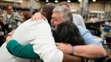 David Meredith, middle, hugs fellow observers after an approval vote at the United Methodist Church General Conference Wednesday, May 1, 2024, in Charlotte, N.C. (AP Photo / Chris Carlson, File)