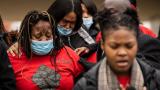 Clifftina Johnson, back left, Tafara Williams' mother, cries as her daughter, Sasha Williams, sings during a press conference outside City Hall in Waukegan, Ill., Tuesday, Oct. 27, 2020. (Ashlee Rezin Garcia / Chicago Sun-Times via AP, File)