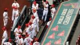 In this July 24, 2020, file photo, members of the St. Louis Cardinals wait to be introduced before the start of a baseball game against the Pittsburgh Pirates in St. Louis. (AP Photo / Jeff Roberson, File) In this July 24, 2020, file photo, members of the St. Louis Cardinals wait to be introduced before the start of a baseball game against the Pittsburgh Pirates in St. Louis. (AP Photo / Jeff Roberson, File)