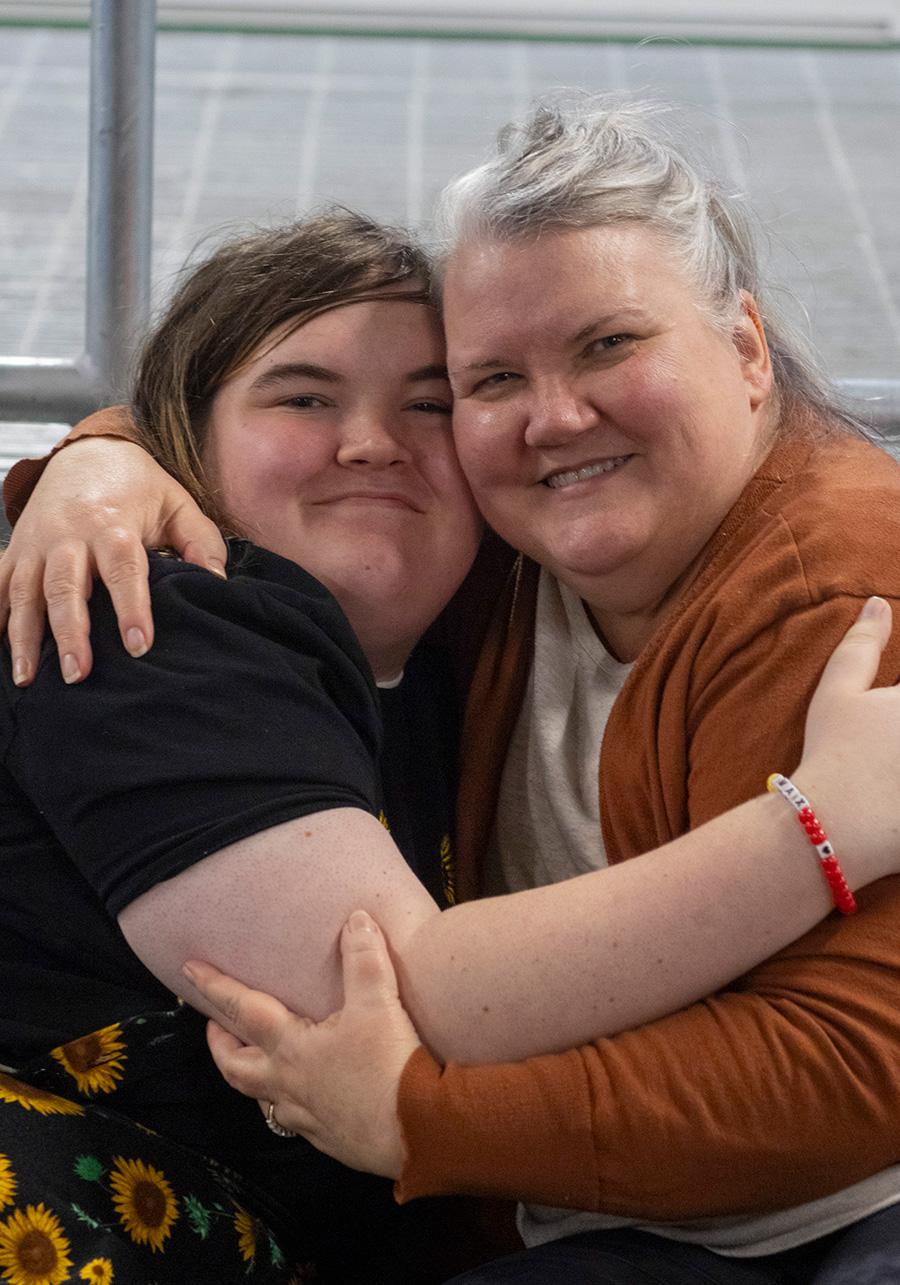 Connie Kathary and Julia Kathary hug each other while sitting for a portrait at a marketplace in Indianapolis, Indiana, in January. (Carly Gist for the Saluki Local Reporting Lab / Capitol News Illinois)