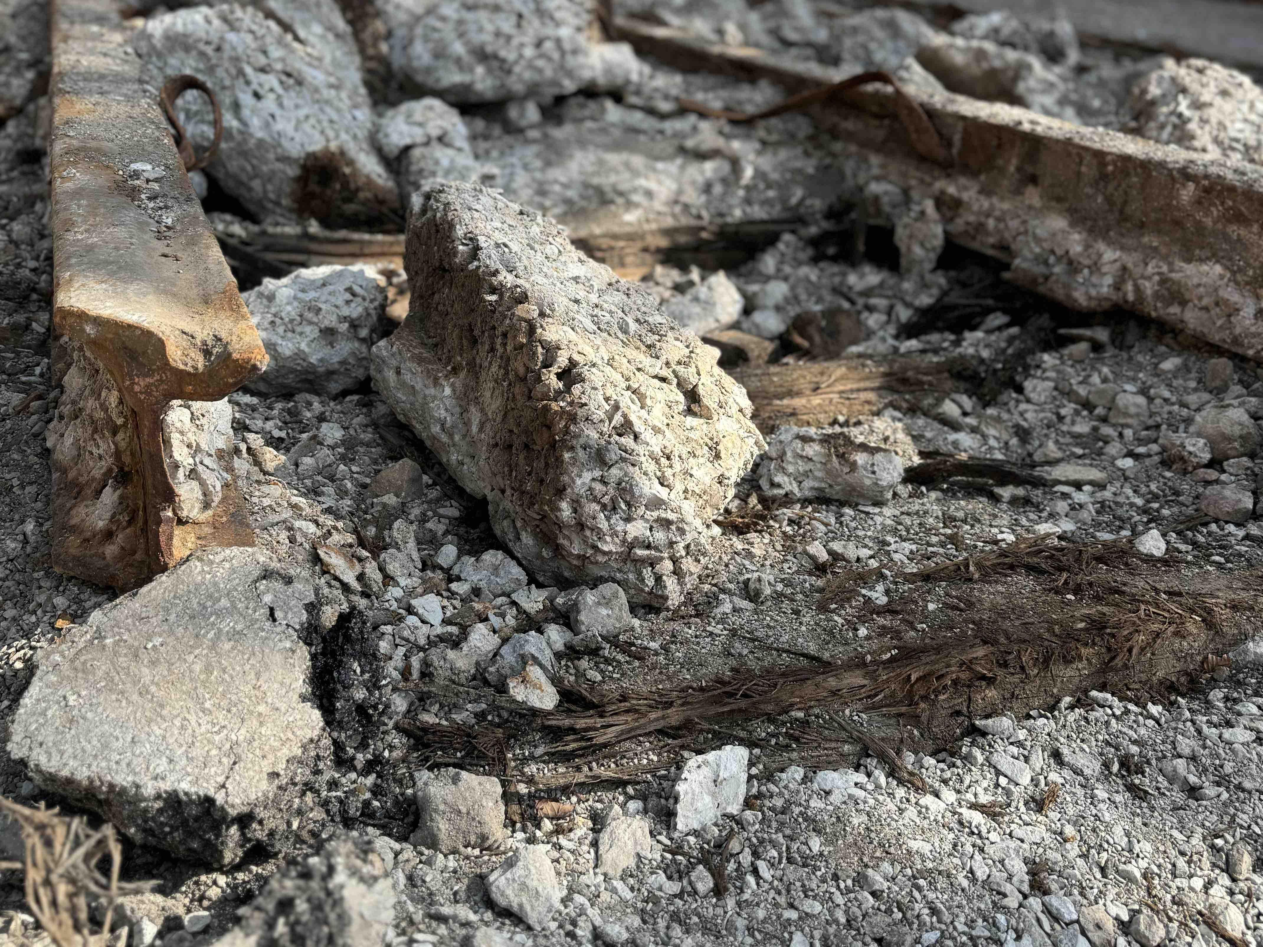 A closeup shows not only the streetcar tracks but the wooden rail ties. Some of the old streetcar rails were ripped out but most, like these in Lincoln Square, were simply paved over. (Patty Wetli / WTTW News)