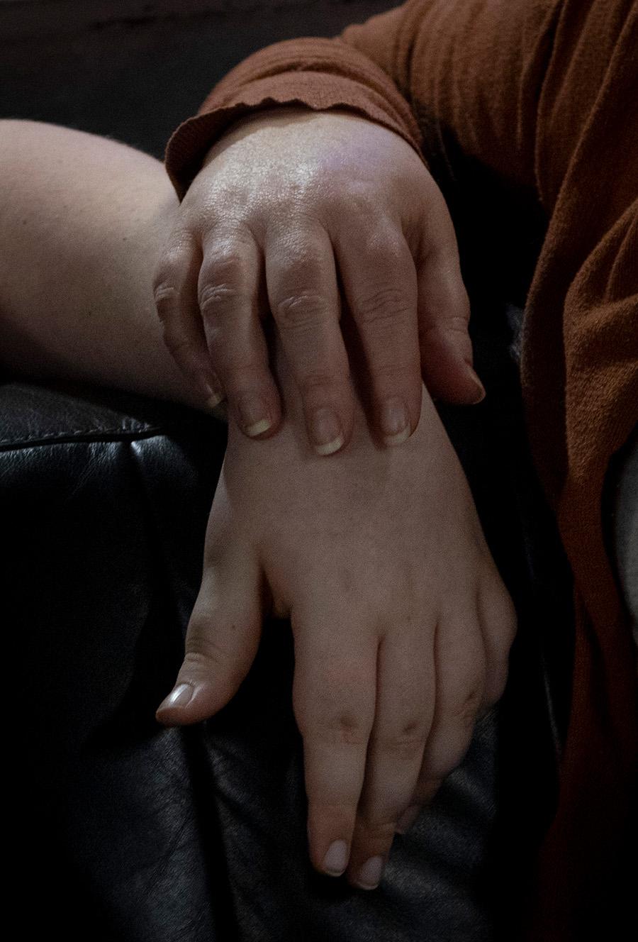 Julia Kathary rests her hand on the wrist of her daughter. (Carly Gist for the Saluki Local Reporting Lab / Capitol News Illinois)