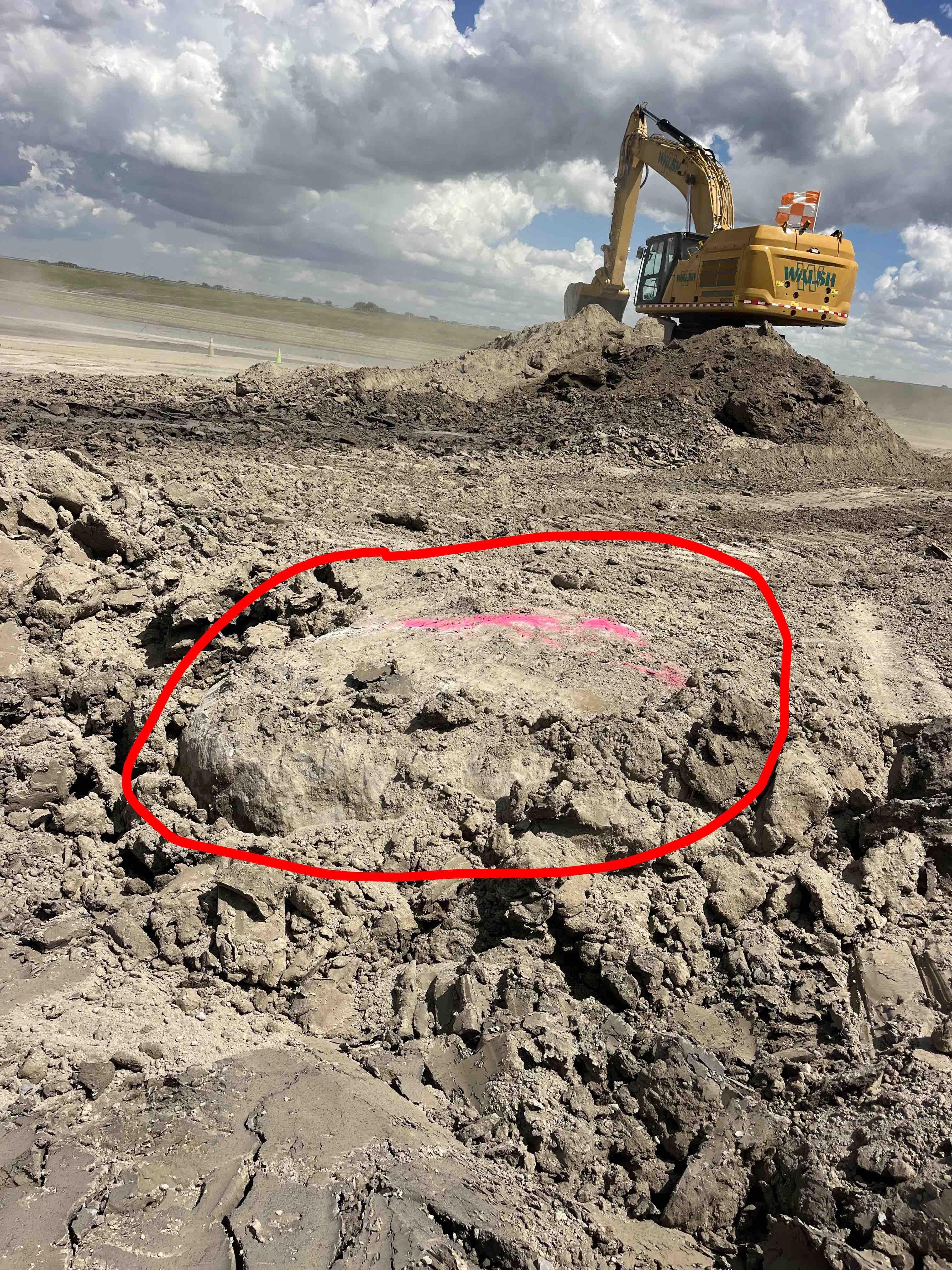 Good eyes! A view of the giant boulder, circled in red, before it was excavated. (Courtesy of Alex Franco)