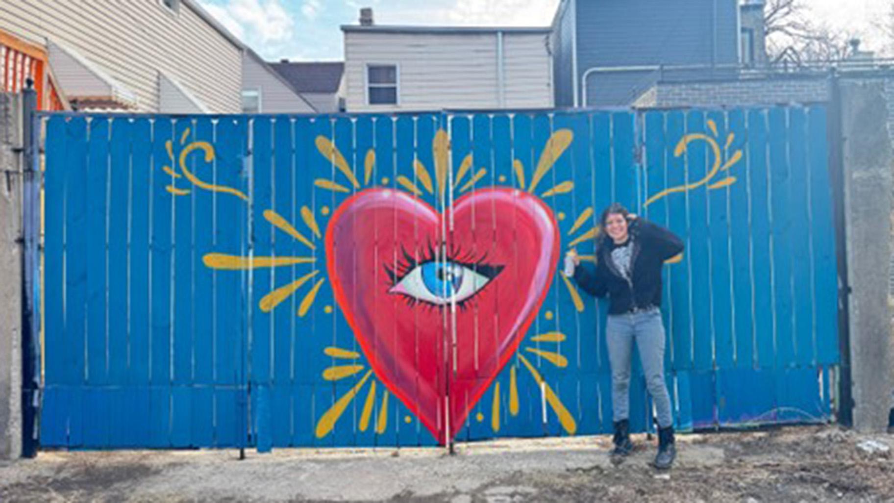 Natalia Sustaita poses with her artwork. (Deedee El bego / Medill School of Journalism)