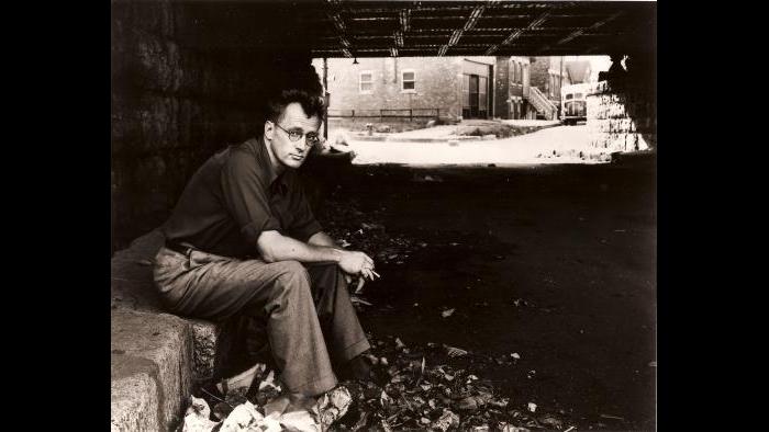 Algren sitting beneath a viaduct in Chicago. (Library of Congress)