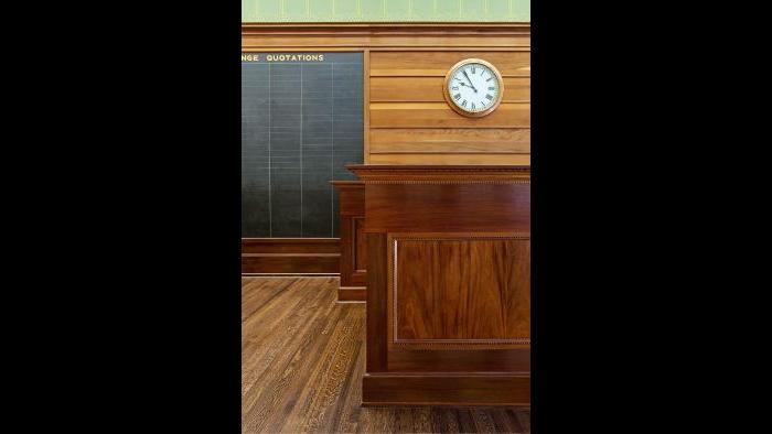 The installation of the mahogany main desk in 1980 completed the Trading Room restoration project.