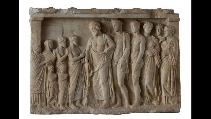 Votive Relief--In the center of this relief, Asklepios, god of medicine, leans on his staff, around which a snake is coiled. This symbol still represents medicine today. (National Archaeological Museum, Athens)