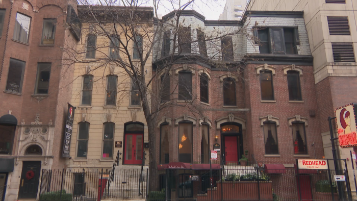 18 W. Ontario St., left, is a limestone Italianate building. 16 W. Ontario St., right, is a brick building in the French-influenced Second Empire style with a mansard roof. (Felix Mendez / WTTW News)