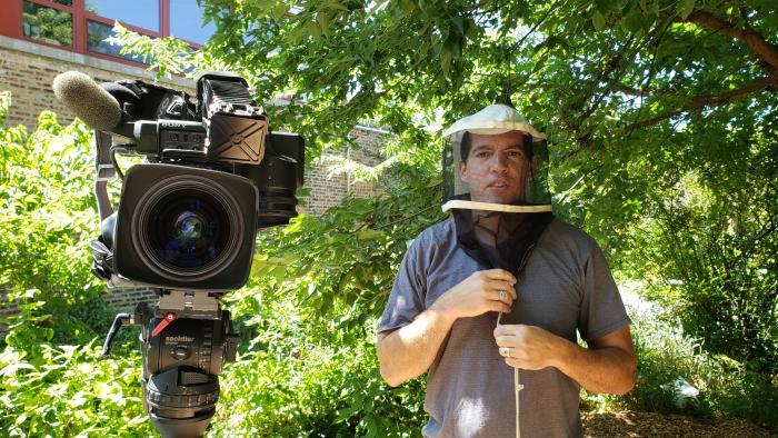 Reporting the story: Cameraman Felix Mendez wears protective gear. (Alex Silets / WTTW News)