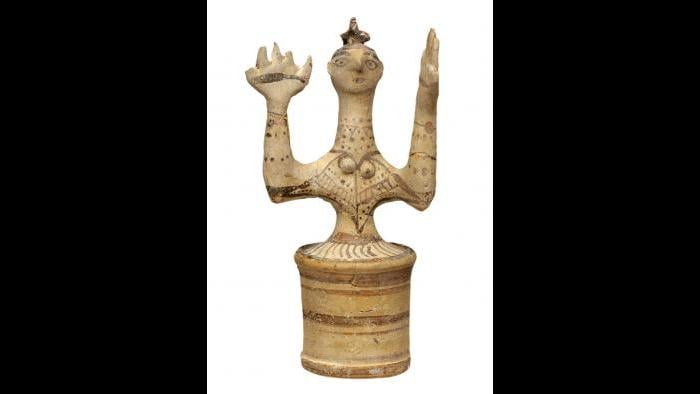 Goddess Figurine--This female figure has a cylindrical skirt, upraised arms, oversized hands, and a bird atop her head, which is interpreted as a symbol of divinity. (Archaeological Museum of Herakleion)