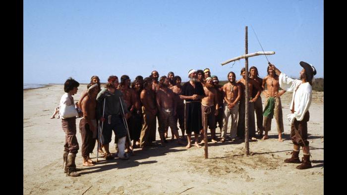 At the Gulf of Mexico at the end of their voyage, Reid Lewis claims the territory for France next to a cross made of driftwood while the crew looks on April 9, 1977. (Photographers of the La Salle: Expedition II)