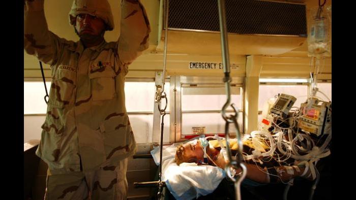 Injured United States soldiers are loaded onto a bus to be taken from the Balad Military Hospital in Iraq. (Lynsey Addario)
