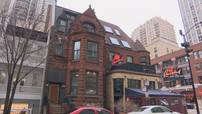 The brownstone at 716 N. Rush St. is a mix of Queen Anne and Romanesque styles. The entryway was remodeled from its original stone arch. (Felix Mendez / WTTW News)