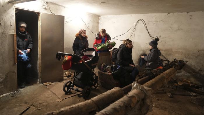 People gather in a shelter during Russian shelling, in Mariupol, Ukraine, Thursday, Feb. 24, 2022. (AP Photo / Evgeniy Maloletka)