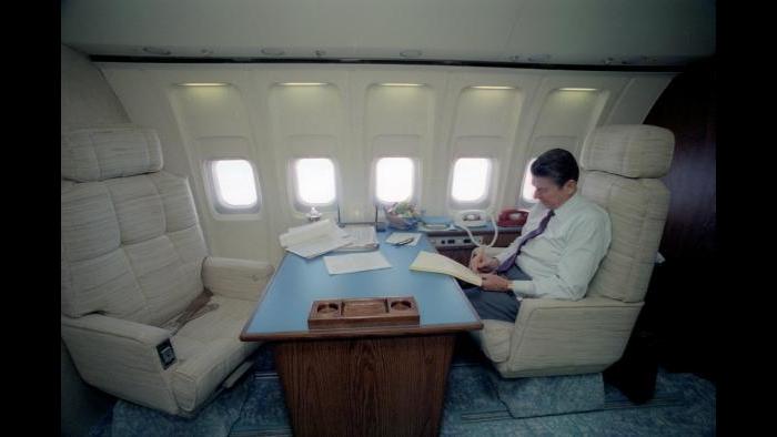 Ronald Reagan in a customary pose, working on his trusty yellow tablet in the stateroom aboard Air Force One, February 19, 1981