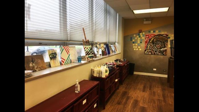 The art that hangs along the hallways at BUILD's headquarters are produced by its participants in the art studio, where materials to paint, spray paint, draw and more are available. (Maya Miller / Chicago Tonight)