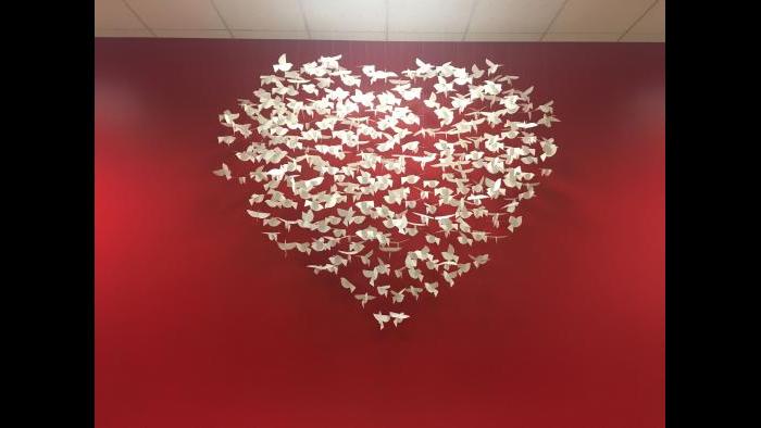 Adam Alonso, the executive director of BUILD Chicago, wanted there to be artistic representations of positivity at the organization's headquarters. (Maya Miller / Chicago Tonight)