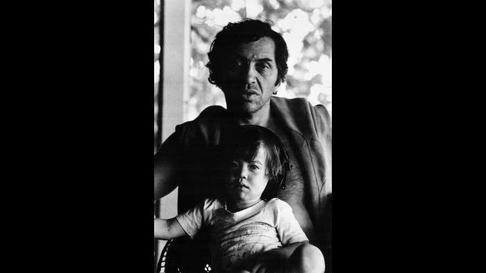 Bill Graham gives his young son David a piggyback ride, 1969. (Bonnie MacLean / Collection of David and Alex Graham)