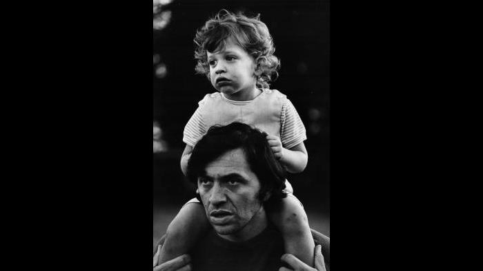 Bill Graham gives his young son David a piggyback ride, 1969. (Bonnie MacLean / Collection of David and Alex Graham)