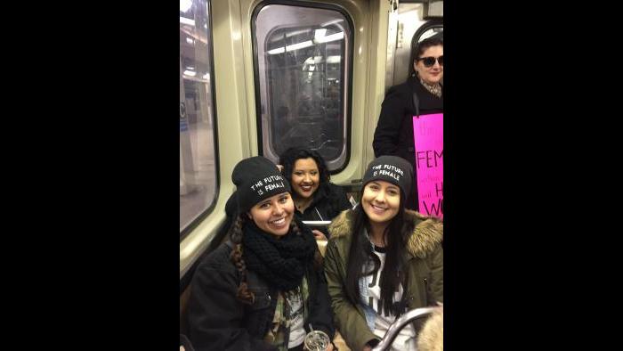 CTA Blue Line train is loaded with activists and their posters en route to the march. (Amanda Vinicky / Chicago Tonight)