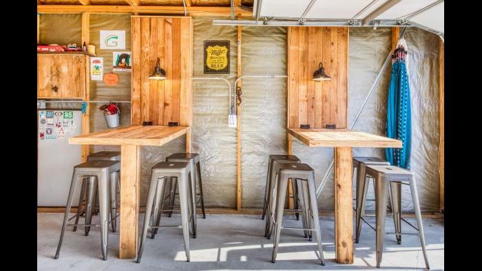 The pub tables are collapsible, to make room for the family's cars in this converted garage. (Courtesy of Chicago Bungalow Association)
