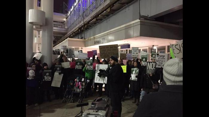 Protesters gather outside Terminal 5 at O'Hare on Saturday. (Paris Schutz / Chicago Tonight)