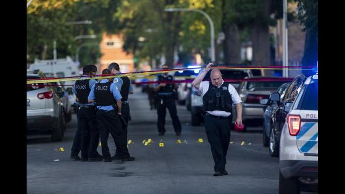 Chicago police officers investigate the scene of a deadly shooting where a 7-year-old girl and a man were fatally shot in Chicago on Sunday, July 5, 2020. (Tyler LaRiviere / Chicago Sun-Times via AP)