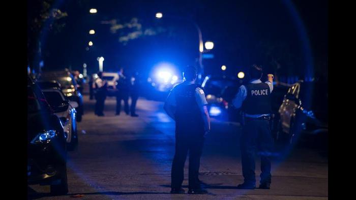 Chicago police officers investigate the scene of a shooting in Chicago on Sunday, July 5, 2020. (Ashlee Rezin Garcia / Chicago Sun-Times via AP)